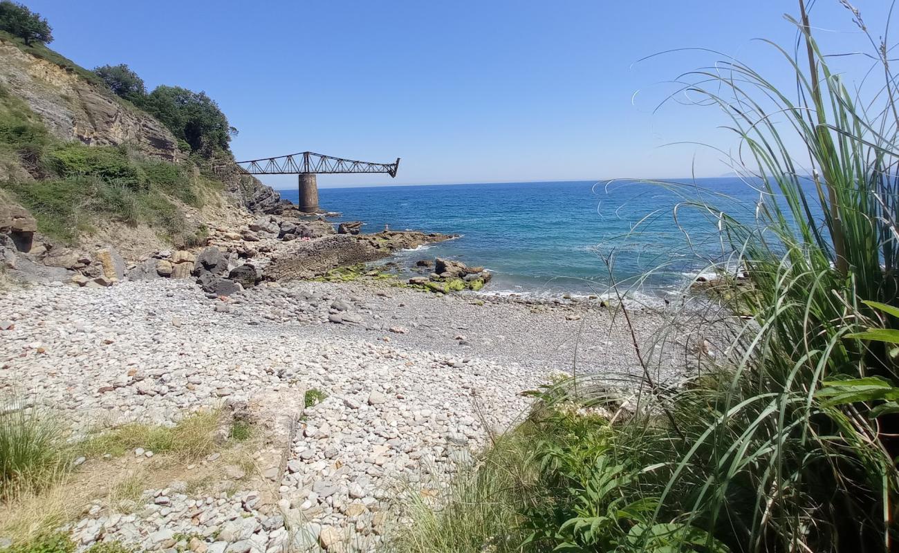 Photo of Cala de Miono with gray pebble surface