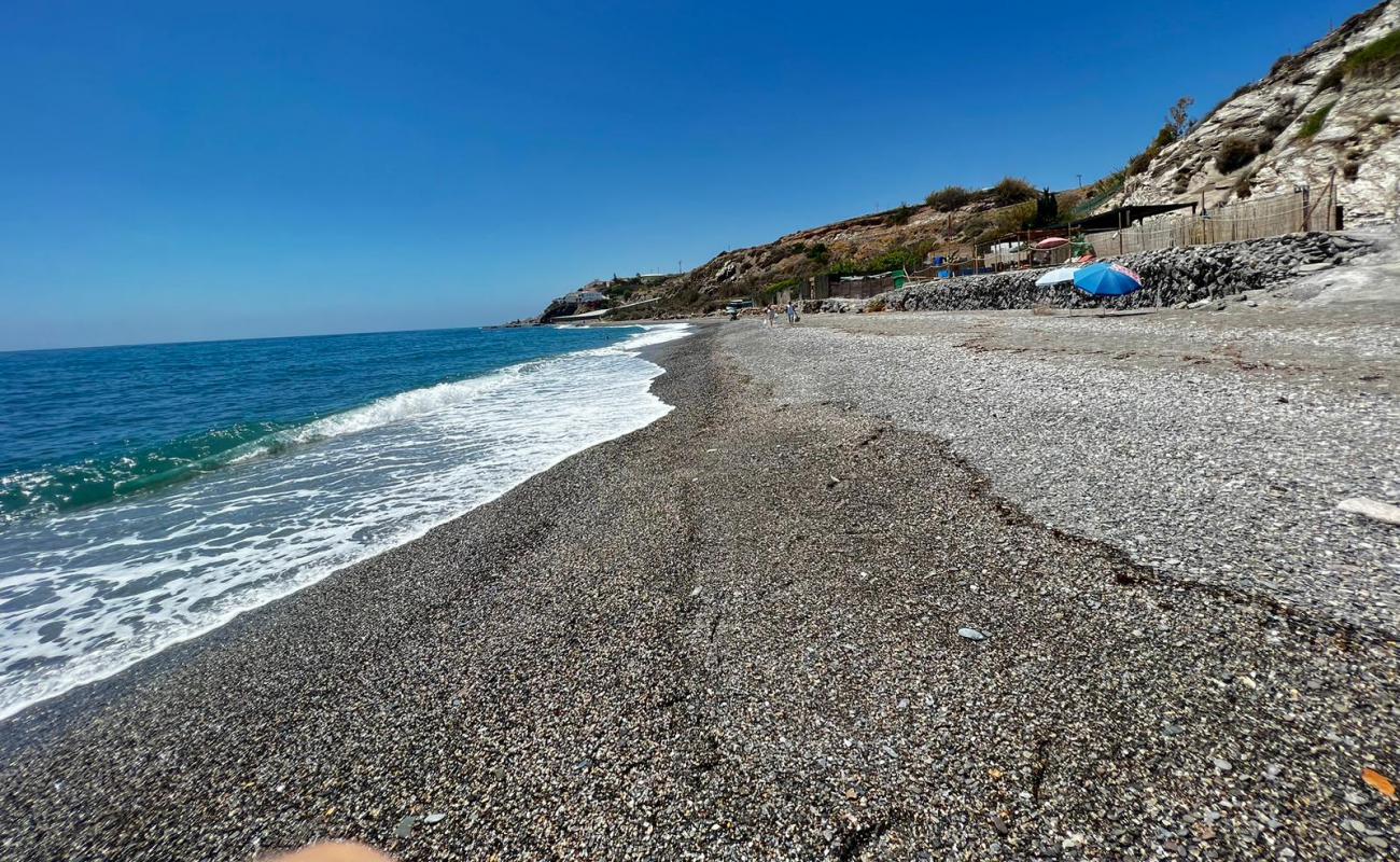 Photo of CalaJunco Beach with gray fine pebble surface