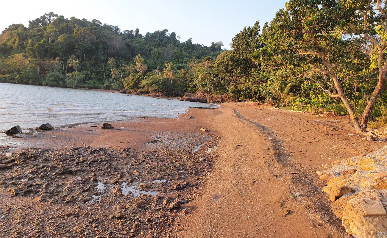 Photo of Natural house Beach with brown sand &  rocks surface