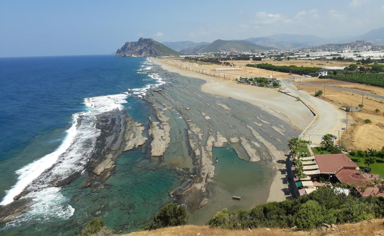 Photo of Bidi Bidi beach with brown sand &  rocks surface