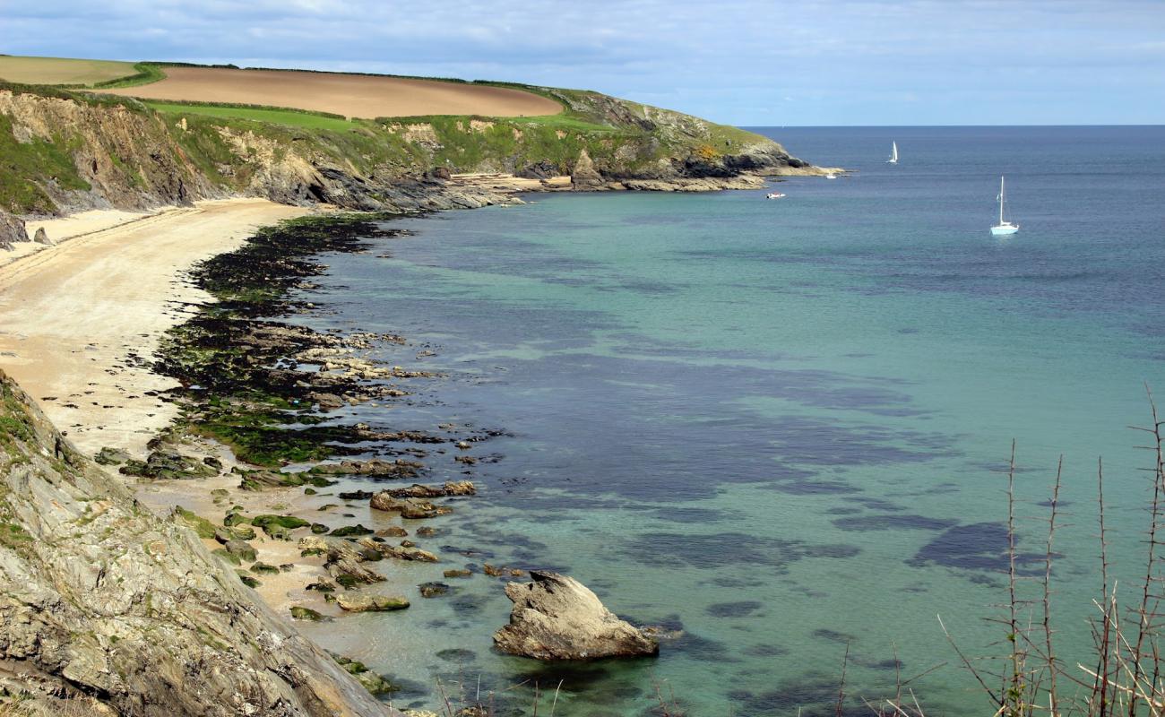 Photo of Porthbean beach with bright sand & rocks surface