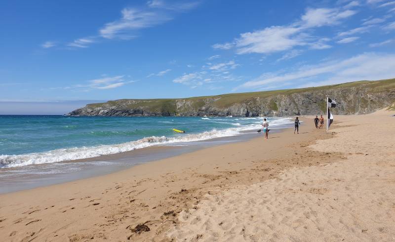 Photo of Holywell Bay with bright sand surface