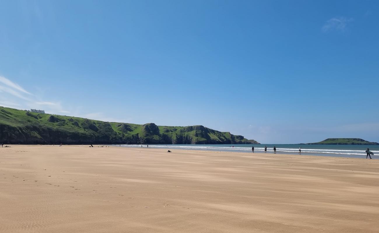 Photo of Rhossili bay beach with gray sand surface