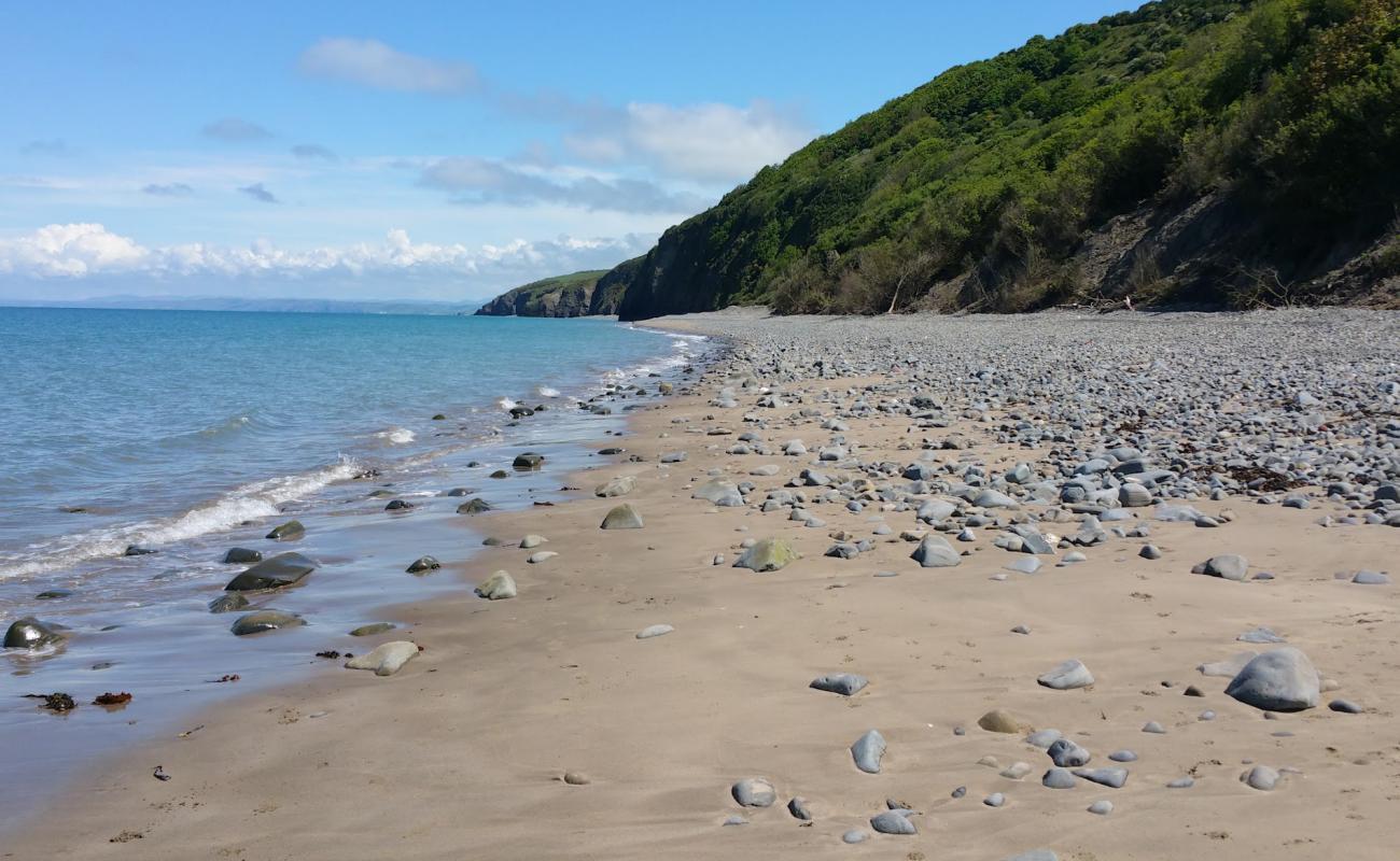 Photo of Cei Bach beach with gray sand &  pebble surface