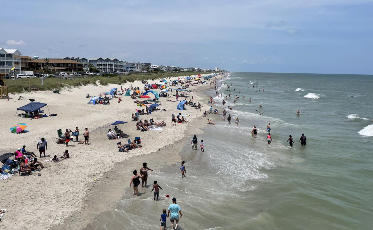 Photo of Kure beach with bright sand surface