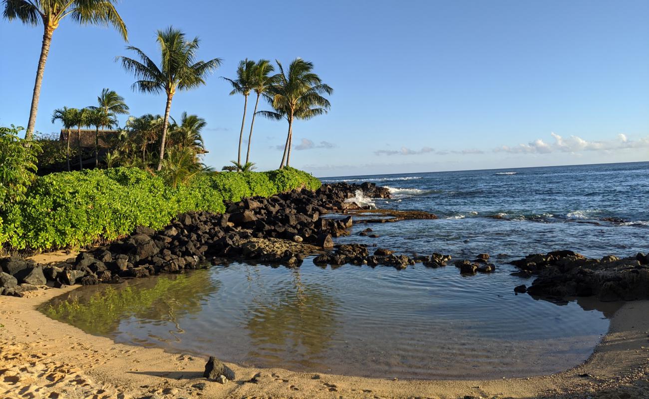 Photo of Keiki Cove Beach with bright sand & rocks surface