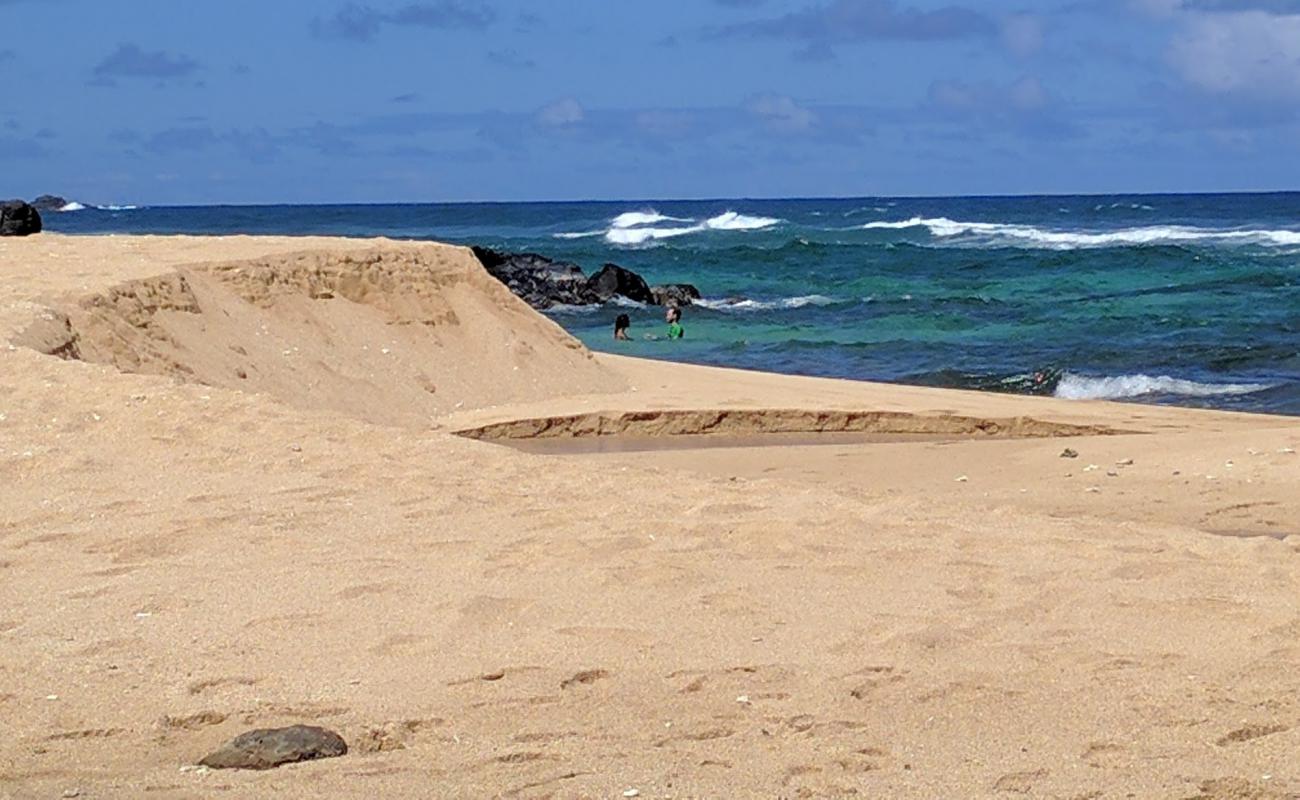 Photo of Kaluakai Beach with bright sand & rocks surface