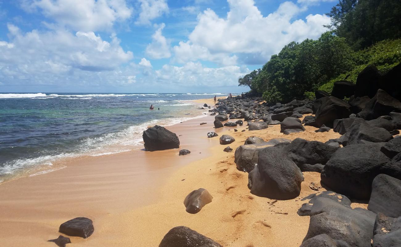 Photo of Anahola Beach with bright sand & rocks surface