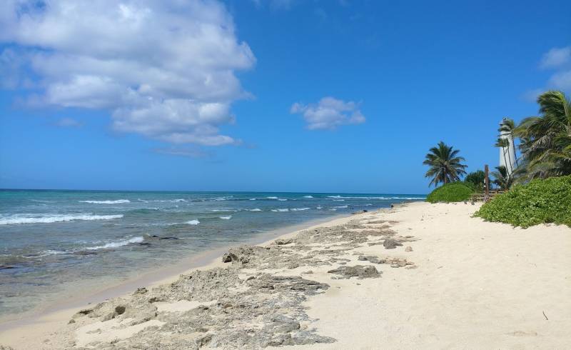 Photo of Barbers Point Beach Park with bright sand & rocks surface