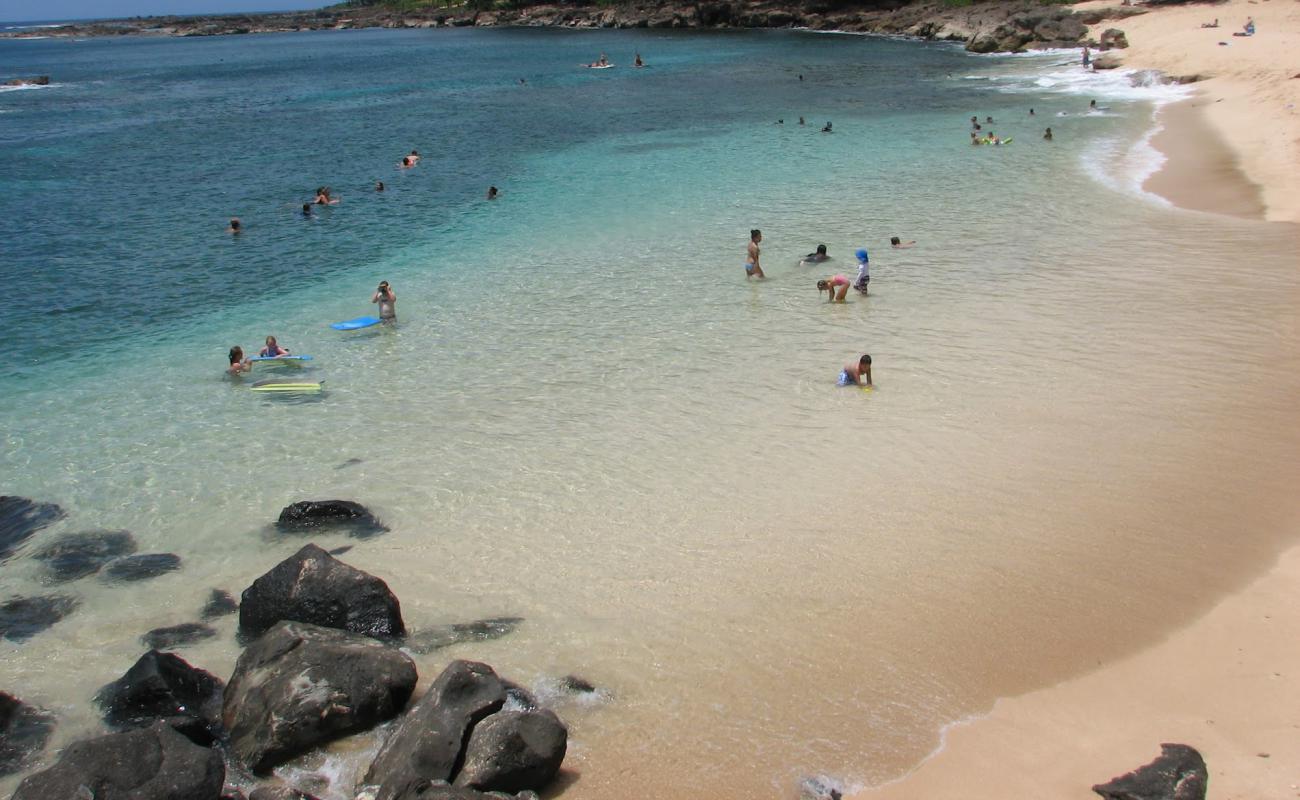 Photo of Three Tables Beach with bright sand & rocks surface