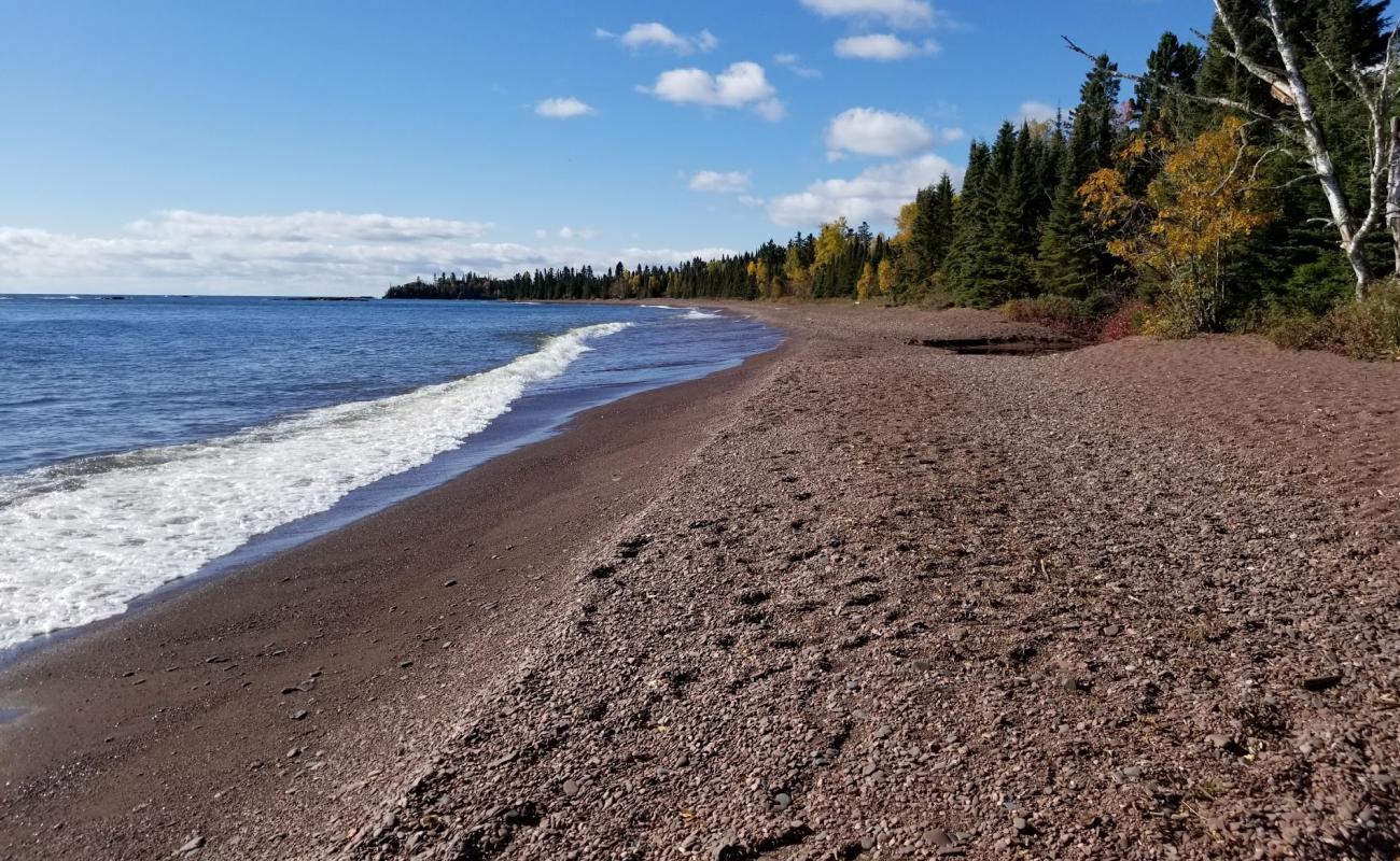 Photo of Paradise Beach with brown sand &  rocks surface