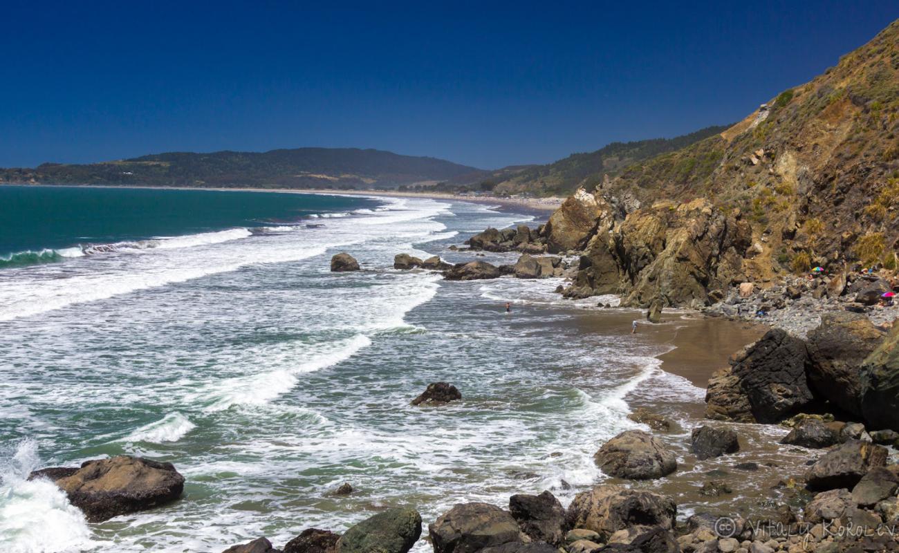 Photo of Red Rock Beach with bright sand surface